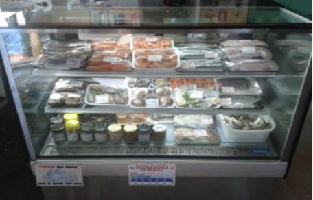 Fresh seafood display case with fish, oysters and pickled seafood